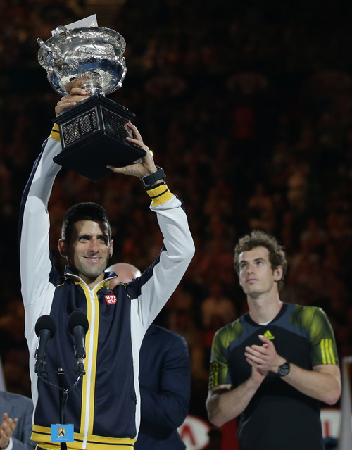 Serbia's Novak Djokovic, left,  holds his trophy aloft after defeating Britain's Andy Murray, right, in the men's final at the Australian Open tennis championship in Melbourne, Australia, Sunday, Jan. 27, 2013. (AP Photo/Dita Alangkara)