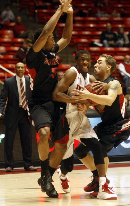 Ashley Detrick  |  The Salt Lake Tribune
Utah Utes guard Jarred DuBois (5) tries to get to the basket in between Stanford Cardinal guard Chasson Randle (5) and guard Aaron Bright (2) during the game against Stanford at Utah Sunday January 27, 2013. Utes were trailing the Cardinals at half, 46-26.