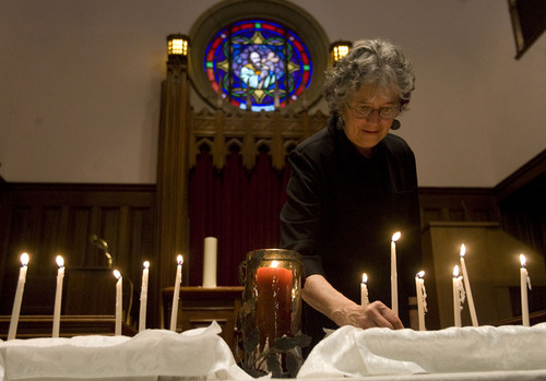 Kim Raff  |  The Salt Lake Tribune
Catherine Kreuter lights a candle and speaks a few words in remembrance of those touched by nuclear testing during the Utah Campaign to Abolish Nuclear Weapons second annual day of remembrance for downwinders at Skaggs Memorial Chapel at First Baptist Church in Salt Lake City on January 27, 2013.