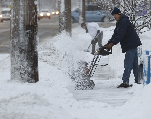 Al Hartmann  |  The Salt Lake Tribune
People dig out by snowblower and shovel during Monday morning's difficult commute.
