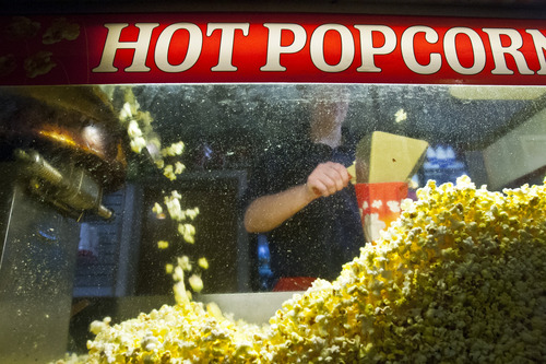 Chris Detrick  |  The Salt Lake Tribune
Allie Braithwaite serves popcorn at the Kaysville Theatre Tuesday January 8, 2013.  The Theatre is located at 21 North Main Street in Kaysville.