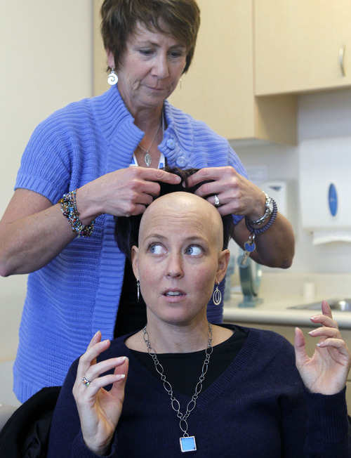 Al Hartmann  |  The Salt Lake Tribune
Cerise Nichol, a breast cancer patient gets fitted with a new wig by Julie Stillman, a cancer patient navigator at Intermountain Medical Center.   IMC  is paving new ground in its team approach to cancer care. Cancer cuts across many departments, from surgery and oncology to genetics and radiology. Providers from each of these disciplines pow wow monthly to weigh the best course of treatment for complicated patients like Cerise. They also mine patient data to guide their decisions. And sometimes the data show the best test or procedure is the most expensive one, says an oncologist who published research that he says is proof of the need to leave health decisions in the hands of doctors instead of insurers.