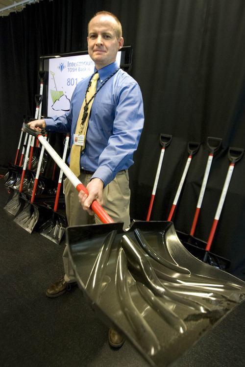 Paul Fraughton  |  The Salt Lake Tribune
 As a participant in the "Snow Shovel Brigade" program, physical  therapist at TOSH (The Orthopedic Specialty Hospital)  Aaron Swalberg shows off one of the hundred snow shovels that the hospital  is giving away free to people who pledge to use the shovels to help others who are physically unable or at risk for injury to shovel their walks and driveways.
 Wednesday, January 30, 2013