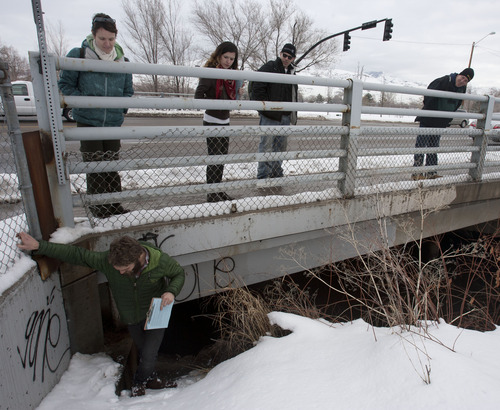 Steve Griffin | The Salt Lake Tribune
Road Home case manager, Buddy Tymczyszyn, crawls out from under an overpass that goes across the Jordan River near 600 North Thursday as his team members Suzie Whisenant, Stephanie Caya, Josh Holdaway and Tim Keffer look on. The team was helping to carry out the annual point-in-time count of homeless people.