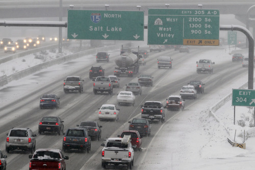 Al Hartmann|  The Salt Lake Tribune
Traffic creeps along I-15 northbound approaching the "spaghetti bowl" during another commuter snow storm Wednesday, Jan. 30.