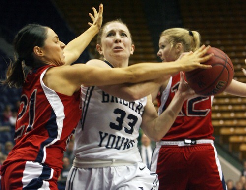 Kim Raff  |  The Salt Lake Tribune
BYU player (middle) Haley Steed is tripped up by St. Mary's players (left) Mia Greco and Hayley Hendricksen during a game at the Marriott Center in Provo on January 31, 2013.