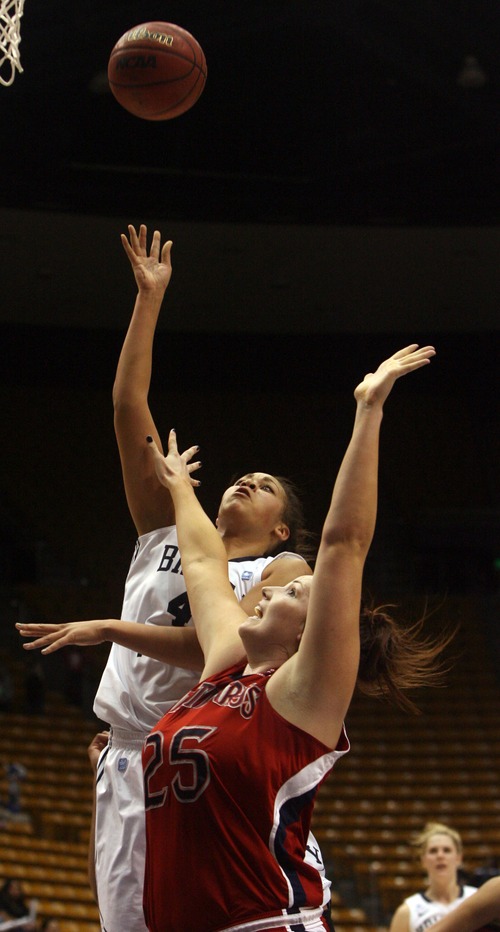 Kim Raff  |  The Salt Lake Tribune
BYU player (left) Keilani Unga takes a shot as St. Mary's players (right) Carli Rosenthal defends during a game at the Marriott Center in Provo on January 31, 2013.   BYU went on to win 66-58.