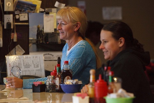 Leah Hogsten  |  The Salt Lake Tribune
Sharon's Cafe owner Sharon Ahern and her daughter Shannon Prescott laugh with customers as they say their goodbyes. Sharon's Cafe, a popular Holladay  diner with plenty of personality, celebrates 10 years of treating regulars and newcomers alike with down home hospitality and warmth,  Friday January 11, 2013 in Holladay.