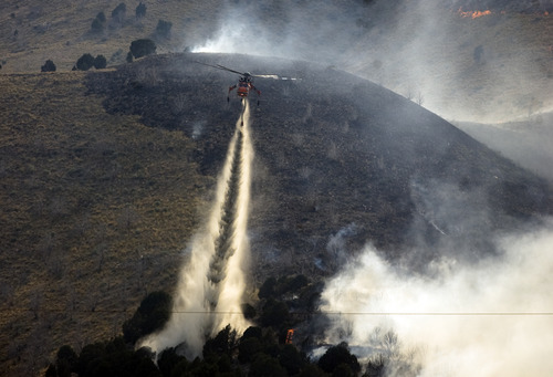 Kim Raff  |  The Salt Lake Tribune
Helicopters are used to try and contain the Dump Wildfire in Saratoga Springs-Eagle Mountain area in Saratoga Springs, Utah.