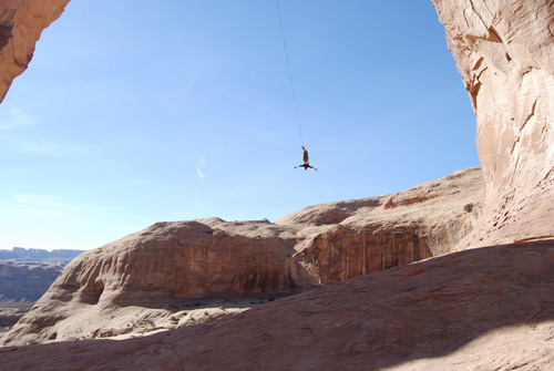 Brian Maffly  |  The Salt Lake Tribune 
Corona Arch near Moab has become what is billed as the world's largest rope swing after climbers figured out how to adapt climbing gear to set up a thrilling 250-foot pendulum ride under the arch. Concerned with liability issues, state officials recently shut down the arch, which is on state-owned land, for commercially guided swinging, pictured here on Nov. 4.