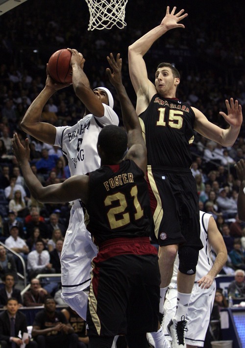 Kim Raff  |  The Salt Lake Tribune
(left) Brigham Young Cougars forward Brandon Davies (0) shoots the ball as (middle) Santa Clara Broncos guard Kevin Foster (21) and Santa Clara Broncos forward Marc Trasolini (15) defend during a game at the Marriott Center in Provo on February 2, 2013.