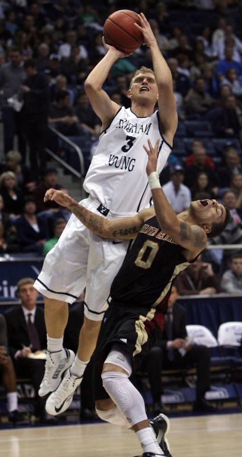 Kim Raff  |  The Salt Lake Tribune
(left) Brigham Young Cougars guard Tyler Haws (3) shoots the ball past Santa Clara Broncos guard Evan Roquemore (0) during a game at the Marriott Center in Provo on February 2, 2013.