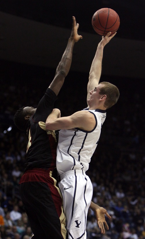 Kim Raff  |  The Salt Lake Tribune
(left) Santa Clara Broncos forward Yannick Atanga (44) defends Brigham Young Cougars forward Josh Sharp (12) as he shoots the ball during a game at the Marriott Center in Provo on February 2, 2013.
