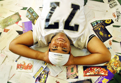Danny La | The Salt Lake Tribune
Highland High School football star Haloti Ngata, now a player for the Baltimore Ravens, is surrounded by letters from colleges that wanted to recruit him including Nebraska, Michigan and UCLA. He ended up at University of Oregon.