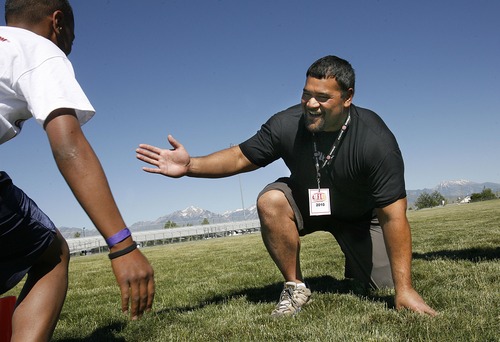 Scott Sommerdorf  |  Salt Lake Tribune

Baltimore Ravens defensive tackle Haloti Ngata (right)  congratulates 12-year-old Tevita Mailau after he did 46 push-ups as part of the football camp held at Copper Hills High for Polynesian players on June 17, 2010. Ngata is one of many Polynesian athletes from Utah who have helped elevate football in the state.