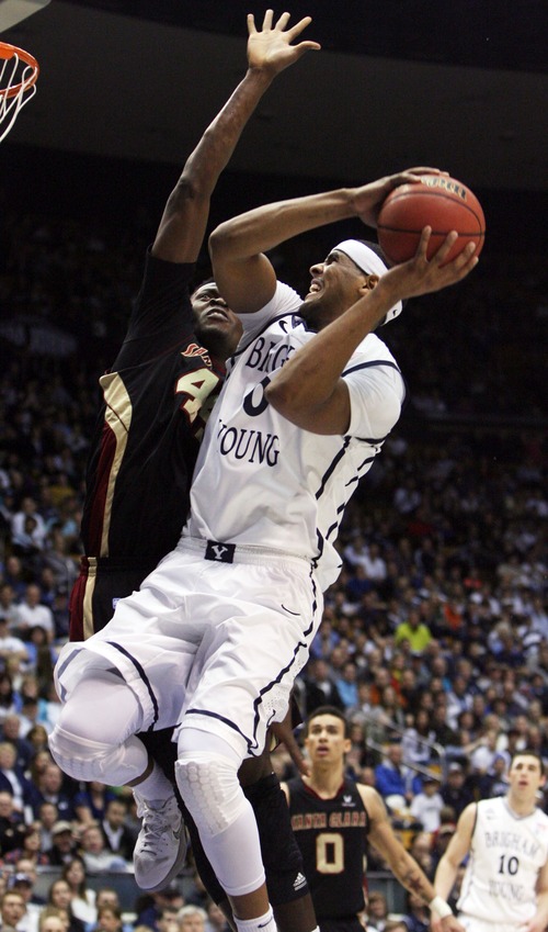Kim Raff  |  The Salt Lake Tribune
(right) Brigham Young Cougars forward Brandon Davies (0) shoots the ball as Santa Clara Broncos forward Yannick Atanga (44) defends during a game at the Marriott Center in Provo on February 2, 2013.  BYU went on to win 96-79.