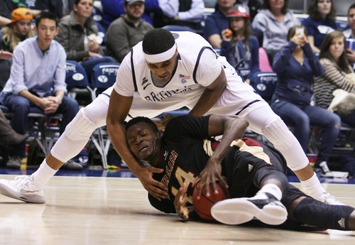 Kim Raff  |  The Salt Lake Tribune
(top) Brigham Young Cougars forward Brandon Davies (0) tries to grab the ball from Santa Clara Broncos forward Yannick Atanga (44) during a game at the Marriott Center in Provo on February 2, 2013.  BYU went on to win 96-79.