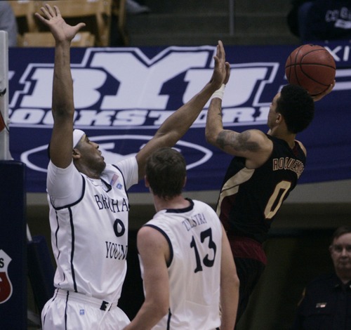 Kim Raff  |  The Salt Lake Tribune
(left) Brigham Young Cougars forward Brandon Davies (0) defends as Santa Clara Broncos guard Evan Roquemore (0) shoots the ball during a game at the Marriott Center in Provo on February 2, 2013.  BYU went on to win 96-79.
