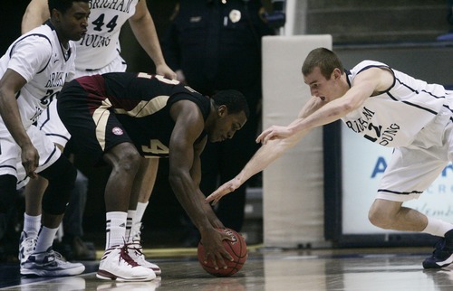 Kim Raff  |  The Salt Lake Tribune
(left) Santa Clara Broncos guard Raymond Cowels III (42) and Brigham Young Cougars forward Josh Sharp (12) compete for a loose ball during a game at the Marriott Center in Provo on February 2, 2013.  BYU went on to win 96-79.
