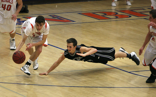 Scott Sommerdorf   |  The Salt Lake Tribune
Brighton's Zach Bernardo dribbles away with a steal as Alta's Tanner Heyland dives to try to regain the ball during first half play. Alta led Brighton 34-25 at the half at Brighton High, Friday, February 1, 2013.