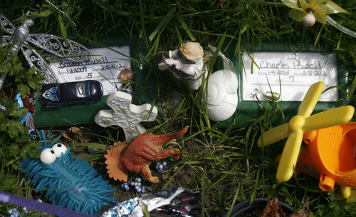 Rick Egan  | The Salt Lake Tribune 

Toys and religious symbols have been left on the graves of Braden and Charlie Powell, in the cemetery in Puyallup Wash. Thursday, May 10, 2012.
