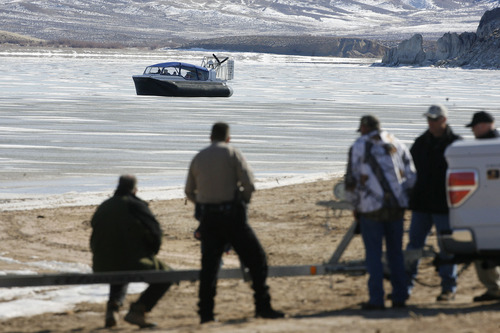 Scott Sommerdorf   |  The Salt Lake Tribune
Daggett County deputies and other Manila residents watch as the new hovercraft goes for a spin on Flaming Gorge Reservoir. The Daggett County Sheriff's office unveiled its new Amphibious Marine Hovercraft at Flaming Gorge Dam near Manila, Utah, Saturday, February 2, 2013.