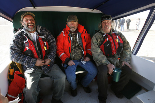 Scott Sommerdorf   |  The Salt Lake Tribune
Ice fishermen Rick Bock, left, Benny Bellon and Mike Musselman were among a group of people who were given rides in the Daggett County Sheriff's Office's new hovercraft. Musselman has fallen through the ice before while fishing and nearly died. Officers unveiled their new Amphibious Marine Hovercraft at Flaming Gorge Dam near Manila, Utah, Saturday, February 2, 2013.
