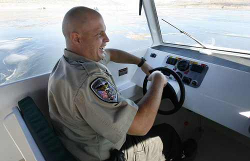 Scott Sommerdorf   |  The Salt Lake Tribune
Daggett County sheriff's Deputy Kenneth Jenkins is clearly excited to get behind the wheel of the department's new hovercraft as he takes a turn to get familiar with the craft. The Daggett County Sheriff's Office unveiled its new Amphibious Marine Hovercraft at Flaming Gorge Dam near Manila, Utah, Saturday, February 2, 2013.