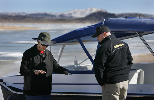Scott Sommerdorf   |  The Salt Lake Tribune
Hovercraft manufacturer Bryan Phillips, left, describes how to handle the hovercraft on ice prior to a training exercise for deputies on Flaming Gorge Reservoir, Saturday, February 2, 2013. The Daggett County Sheriff's Office unveiled its new Amphibious Marine Hovercraft at Flaming Gorge Dam near Manila.