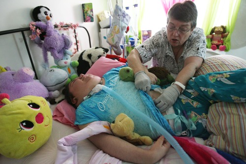 Kim Raff  |  The Salt Lake Tribune
Brenda Kehoe, Valerie Sowby night nurse helps with her daily care at her home in Bountiful on February 3, 2013.  Sowby's mother Heather was told that her daughter wouldn't live to see her first birthday. Now she is 16, and due to an experiment to cut costs of Medicaid, Valerie's night nurse is no longer covered on their plan.