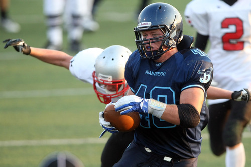 Chris Detrick  |  The Salt Lake Tribune
Juan Diego's Dakota Cox (49) scores a touchdown past Manti's Tyler Albee (19) during the game at Juan Diego High School on Aug. 24, 2012. Cox has committed to pay at University of New Mexico.