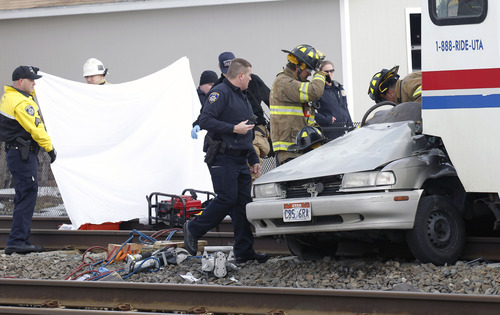 Al Hartmann  |  The Salt Lake Tribune
South Salt Lake police and fire department paramedics work to remove person in car hit by TRAX Train at 2950 South 200 West Wednesday morning February 6.