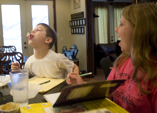 Kim Raff  |  The Salt Lake Tribune
Annie laughs as her brother Denney Simmons tries to catch a piece of popcorn in his mouth at their home in Kamas on Jan. 24, 2013.  John and Amy Simmons have nine children with five adopted from Russia, including Annie and Denney.  The couple is upset with the Russian government ban on U.S. adoptions from Russia.