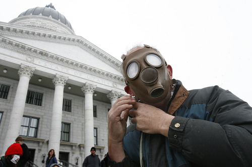Scott Sommerdorf   |  The Salt Lake Tribune
Bart Tippetts puts on a gas mask prior to participating in the clean air rally on the south steps of the Capitol building, Wednesday, February 6, 2013.