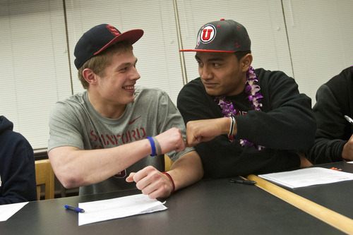 Chris Detrick  |  The Salt Lake Tribune
Sean Barton and Filipo Mokofisi fist bump after signing their letter of intent at Woods Cross High School on National Signing Day Wednesday February 6, 2013. Barton will be playing football at Stanford and Mokofisi will be playing football at University of Utah.