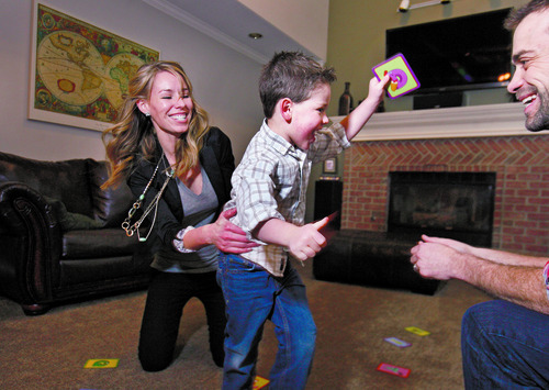Scott Sommerdorf   |  The Salt Lake Tribune
Anne Robertson is a mom who recently took a leave from work under the act to care for her infant. Here, she holds her son Ryker, 3, as he runs to his dad, Graham Weddick, as they play an alphabet game at their home in Cottonwood Heights, Friday, February 8, 2013.