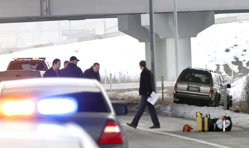 Al Hartmann  |  The Salt Lake Tribune
Utah Highway Patrol investigates SUV at right in an apparent murder-suicide near the Redwood Road exit on eastbound I-80 Friday February 8.