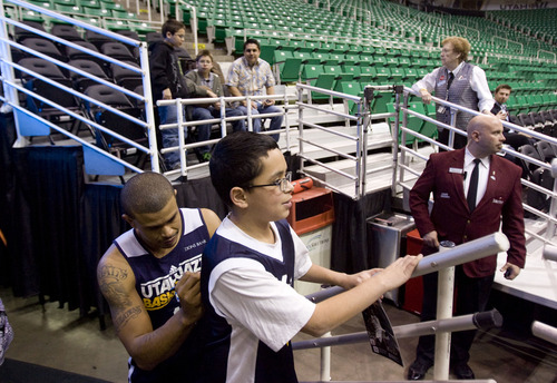 Kim Raff  |  The Salt Lake Tribune
Utah Jazz point guard Earl Watson (11) signs an autograph on the back of Michael Osorio's jersey before a game against the Chicago Bulls at EnergySolutions Arena in Salt Lake City on February 8, 2013.
