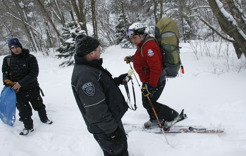 Scott Sommerdorf   |  The Salt Lake Tribune
Salt Lake County Sheriff's search and rescue team members check their beacons as they head out to search for a male who was buried up to his neck in an avalanche near Broads Fork Canyon, Sunday, February 10, 2013. The man was rescued late Sunday.