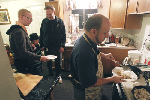 Al Hartmann  |  The Salt Lake Tribune
The Rev. Robert Trujillo, right, makes breakfast for his children Jordan Kersey, 20, Dillan Whitlock 8, and his partner, Mark Dexheimer-Trujillo, Friday. Trujillo can legally marry people but can't get married to his longtime partner, Mark, who together, have raised seven children.
