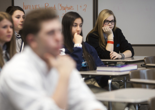 Juan Diego Catholic High School juniors reflect and ask questions during their morning theology class about the recent news that Pope Benedict XVI will resign at the end of the month. (CAYCE CLIFFORD/Special to The Tribune)
