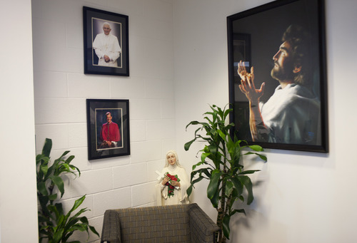 Photos, statues and paintings of religious figures in the main office of Juan Diego Catholic High School. (CAYCE CLIFFORD/Special to The Tribune)