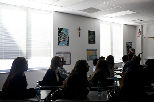 Juan Diego Catholic High School juniors watch a video highlighting the news of Pope Benedict XVI's resignation in their morning theology class. The class, already focusing their week's studies on the papacies, discussed the historical and dramatic moment that the world was witnessing. (CAYCE CLIFFORD/Special to The Tribune)