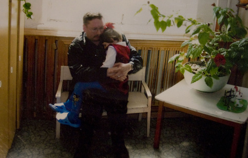 Kim Raff  |  The Salt Lake Tribune
John Simmons holds Sarah in the orphanage where she was adopted in Partizansk, Russia. John and Amy Simmons have nine children with five adopted from Russia, including Sarah and three of her biological sisters.
