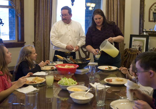 Kim Raff  |  The Salt Lake Tribune
John and Amy Simmons eat dinner with their family at their home in Kamas on January 24, 2013. The couple have nine children with five adopted from Russia.