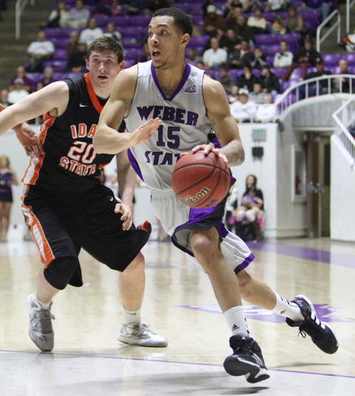 Rick Egan  | The Salt Lake Tribune 

Weber State Wildcats guard/forward Davion Berry (15) takes the ball inside, as Idaho State Bengals guard/forward Chris Hansen (20) defends, in basketball action at the Dee Event Center in Ogden, Monday, February 11, 2013.