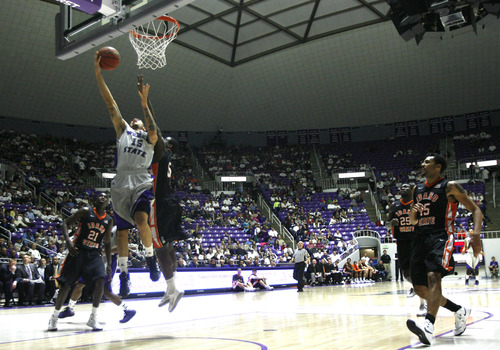 Rick Egan  | The Salt Lake Tribune 

Weber State Wildcats guard/forward Davion Berry (15) scores as Idaho State Bengals guard Sherrod Baldwin (5) defends,  in basketball action at the Dee Event Center in Ogden, Monday, February 11, 2013.