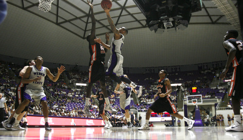 Rick Egan  | The Salt Lake Tribune 

Weber State Wildcats guard Gelaun Wheelwright (0) takes the ball inside for a lay-up, as Idaho State Bengals center Ayibakuro Preh (25) defends, in basketball action at the Dee Event Center in Ogden, Monday, February 11, 2013.