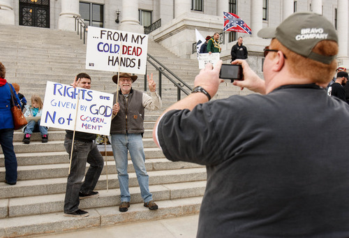 Trent Nelson  |  The Salt Lake Tribune
Josh Harris and Dave Larson pose for a photograph (being taken by Joe Harris) at a gun rally on the steps of the state Capitol Friday, February 8, 2013 in Salt Lake City.