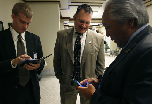Scott Sommerdorf   |  The Salt Lake Tribune
Clark Aposhian, center, speaks with Rep. Curt Oda, R-Clearfield, right, in the House building at the Utah State Capitol complex, Wednesday, February 6, 2013. Oda is considered the most active advocate of gun rights in the House. Aposhian spends long days at the capitol every day during the legislative session advocating for gun rights. At left is Oda's intern, Nate Osborne.